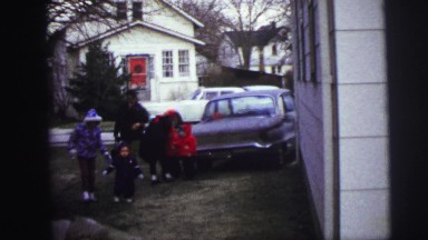 1973: cold child bundled up with overcoat clothing going home LYNBROOK, NEW YORK