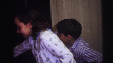 1973: three children decorating christmas tree with lights LYNBROOK, NEW YORK