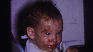 1973: birthday party cake covered baby smiles eating frosting LYNBROOK, NEW YORK