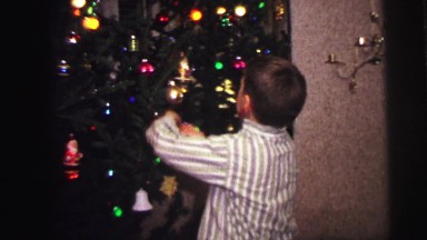 1973: boys hanging christmas ornaments in their pajamas LYNBROOK, NEW YORK