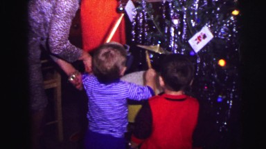 1973: christmas tree is seen with child opening presents LYNBROOK, NEW YORK