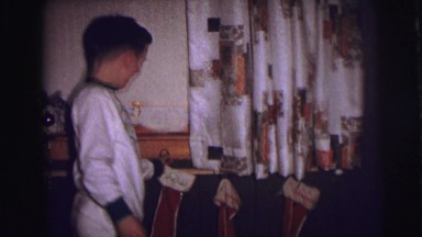 1973: happy kids hanging up xmas stocking ready to get some serious candy