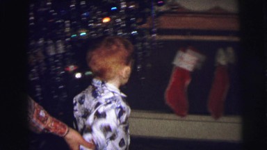1973: little boy is trying to get his christmas sock LYNBROOK, NEW YORK