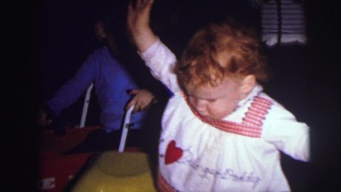 1973: toddlers playing with toys trucks in basement of home LYNBROOK, NEW YORK