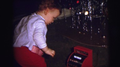 1973: christmas tree is seen with child opening presents LYNBROOK, NEW YORK