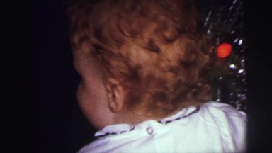 1973: excited child with christmas present LYNBROOK, NEW YORK