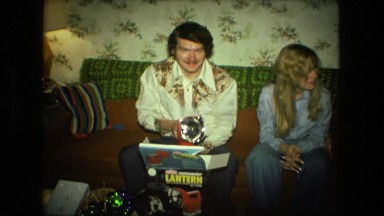1974: family opening christmas presents talking and commenting posing for camera