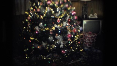 1974: christmas tree is seen with child opening presents FORT WAYNE, INDIANA