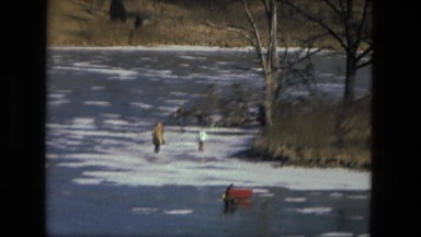 1974: fishers are walking on the frozen river FORT WAYNE, INDIANA