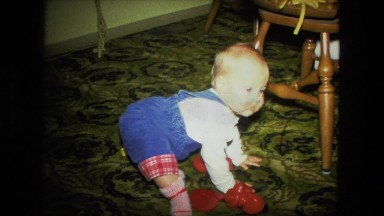 1974: cute kid sitting on the floor with his red color toys FORT WAYNE, INDIANA