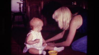 1974: mom is collecting mess from little girl FORT WAYNE, INDIANA