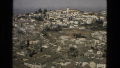 1978: rolling hills of houses on hills and zoom into interior reflection pond