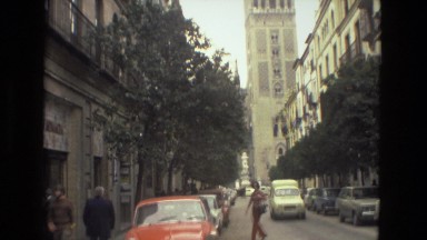 1978: lady walking in front of historic buildings in the middle of the street