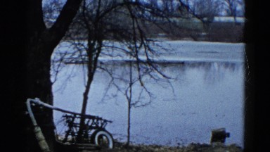 1960: View of Partially Frozen Lake Through Trees in Wauconda, Illinois