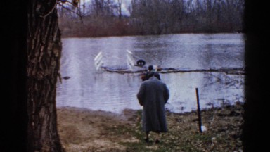 1960: man and woman walking to waters edge WAUCONDA, ILLINOIS
