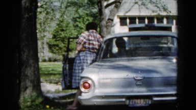 1960: full-figured woman in plaid dress wiping her nose WAUCONDA, ILLINOIS