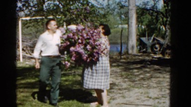 1960: Woman Giving Lilac Bouquet to Friend in Wauconda, Illinois