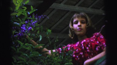 1967: young teenage girl with purple flower bush plant BRAZIL