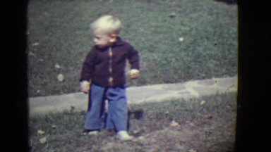 1946: young boy backs up into front yard DETROIT, MICHIGAN