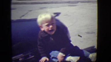 1946: Little Boy Sliding Outdoors in Detroit, Michigan