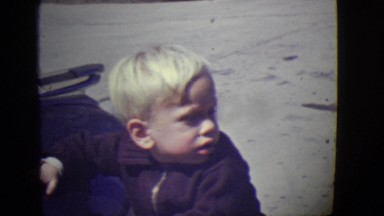 1946: cute blonde kid hitting car hood standing in glory DETROIT, MICHIGAN