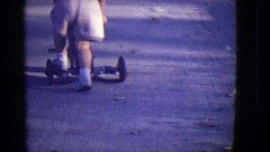 1946: toddler learns to ride scooter DETROIT, MICHIGAN
