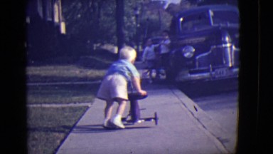 1946: toddler with tricycle being picked on by an older boy DETROIT, MICHIGAN