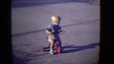 1946: cute blonde kid pushing tricycle around smoother surface asphalt DETROIT