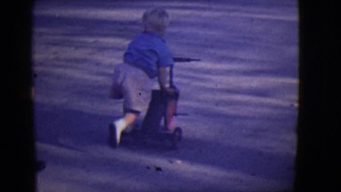 1946: gang of cute kids riding bikes and tricycles down the sidewalk DETROIT