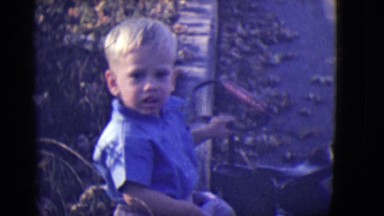 1946: young boy walking with tricycle DETROIT, MICHIGAN