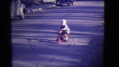 1946: two little boys riding tricycles or road in early fall DETROIT, MICHIGAN