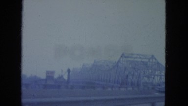 1965: bridge is seen from mountain area with greenery and trees WAUPACA