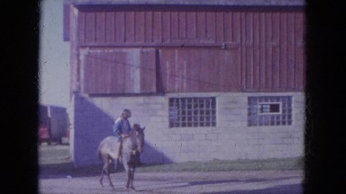 1965: young woman rides gray horse with young man who rides brown horse WAUPACA