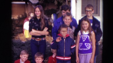 1974: group of children along with woman standing in front of house LINCOLN