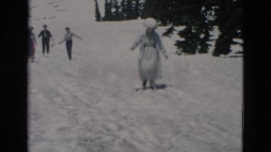 1958: couple walking up glacier ice melt in summer time to take picture WYOMING