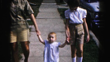 1962: people teaching child how to walk down the sidewalk HAGERSTOWN, MARYLAND