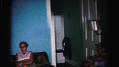 1962: family sitting on couches during holiday enjoying time together watching