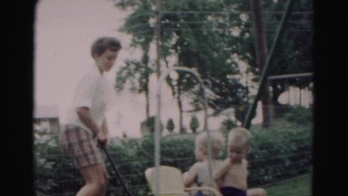 1962: woman wheels younger children around backyard in rural area HAGERSTOWN