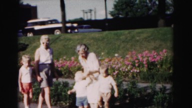 1962: two women and three children gathering in front of flowers HAGERSTOWN