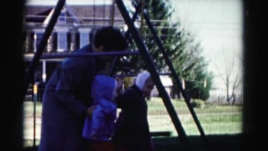 1962: little girls with their mom on swing HAGERSTOWN, MARYLAND