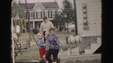 1962: woman walking down stairs with children HAGERSTOWN, MARYLAND