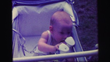 1972: Tender Moment When Baby Plays With Plush Toy In Crib Lynbrook