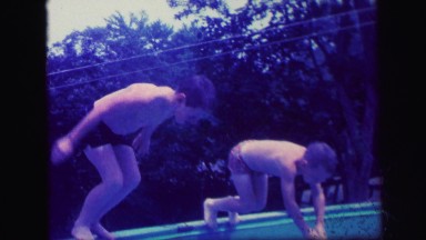 1972: slow motion kids diving swimming pool waters racing LYNBROOK, NEW YORK