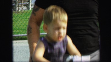 1972: brunette toddler boy bouncing on toy playground park LYNBROOK, NEW YORK