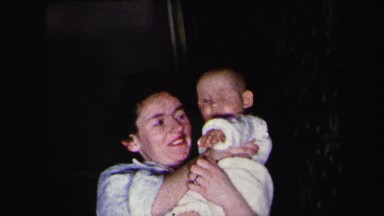 1972: happy mother holding baby girl up proudly LYNBROOK, NEW YORK