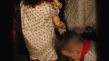1972: baby carrying doll in pajamas xmas morning LYNBROOK, NEW YORK
