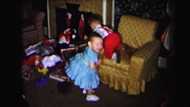 1972: brother sister playing living room family time formal dress holiday time
