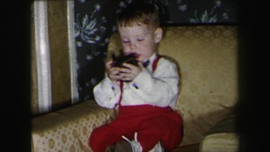 1972: boy playing sister runs past happy indoors LYNBROOK, NEW YORK