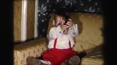 1972: small boy playing with wallet LYNBROOK, NEW YORK