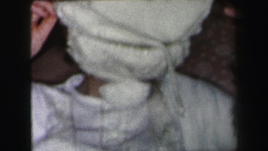 1972: woman smiles and hiding behind the hat LYNBROOK, NEW YORK